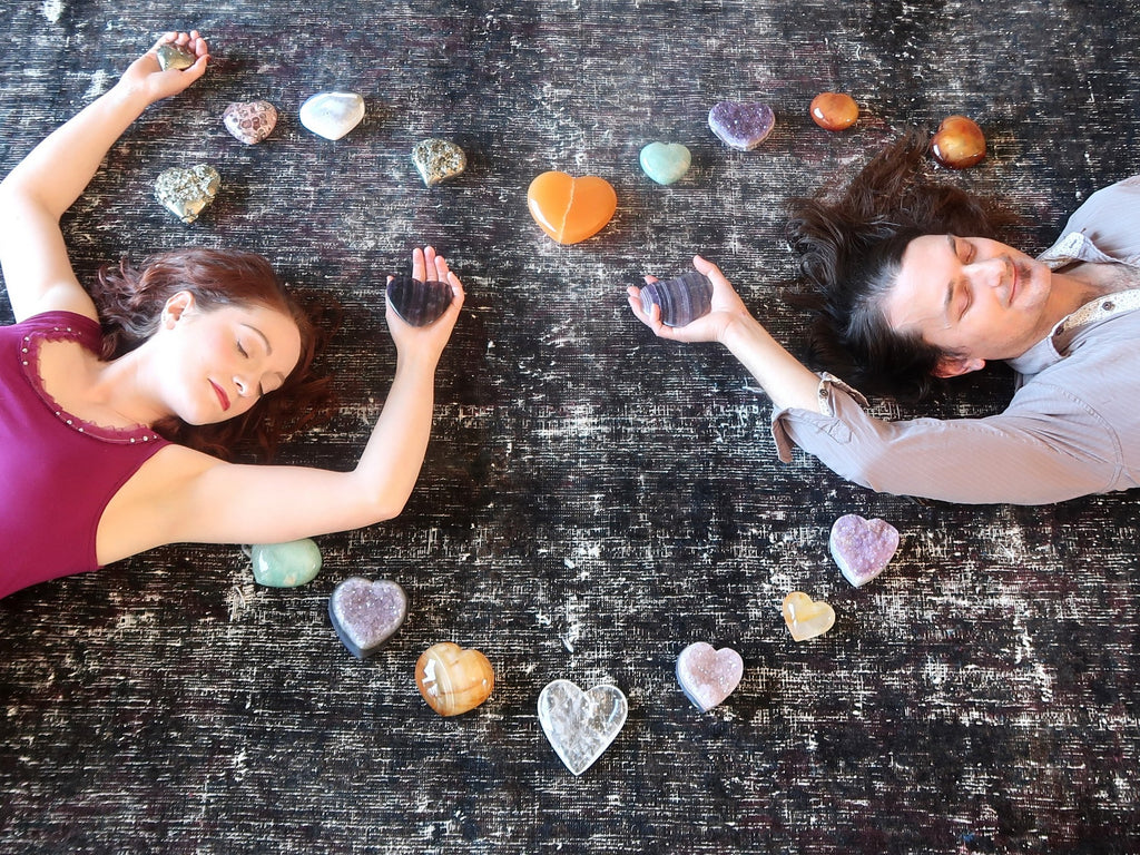 man and woman lying in a crystal heart grid