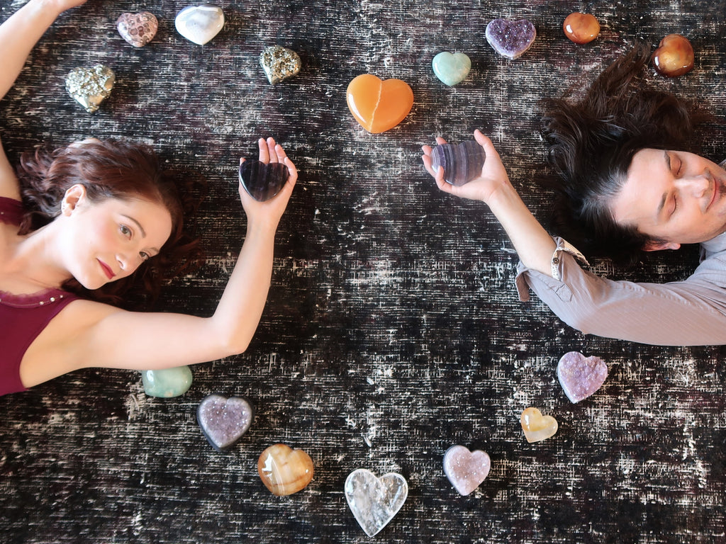 man and woman lying in a grid of crystal hearts