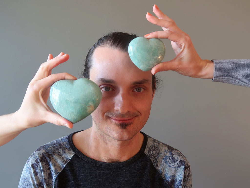 man with amazonite hearts at his face