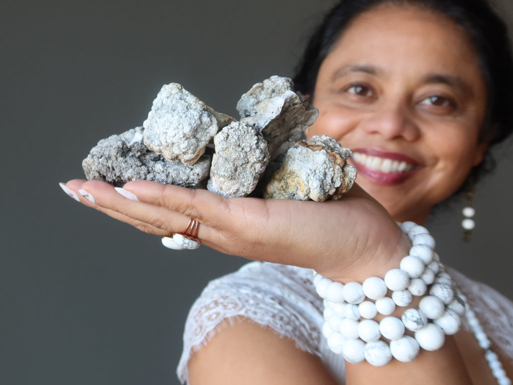 sheila of satin crystals holding pile of raw howlite