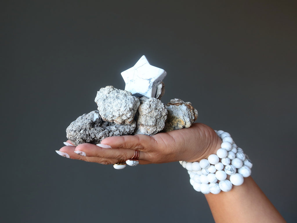 hand holding rough and polished howlite star 