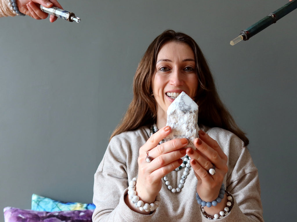 woman holding howlite tower with lapis and aventurine wands pointed at her