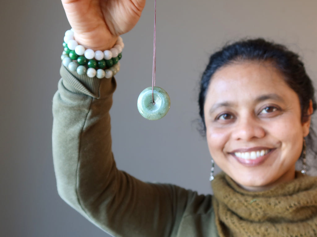 sheila of satin crystals holding jade amulet