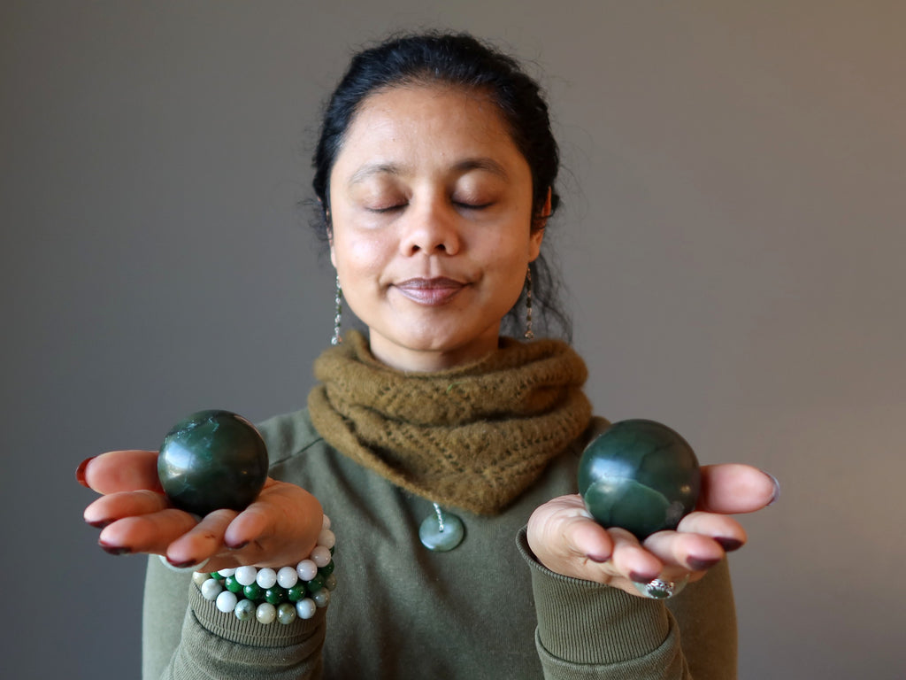 woman meditating with two jade spheres