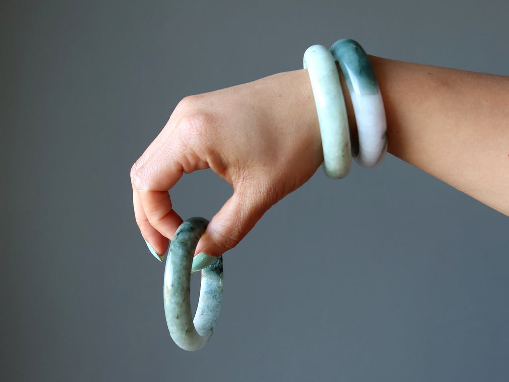 hand wearing and holding jade bangles