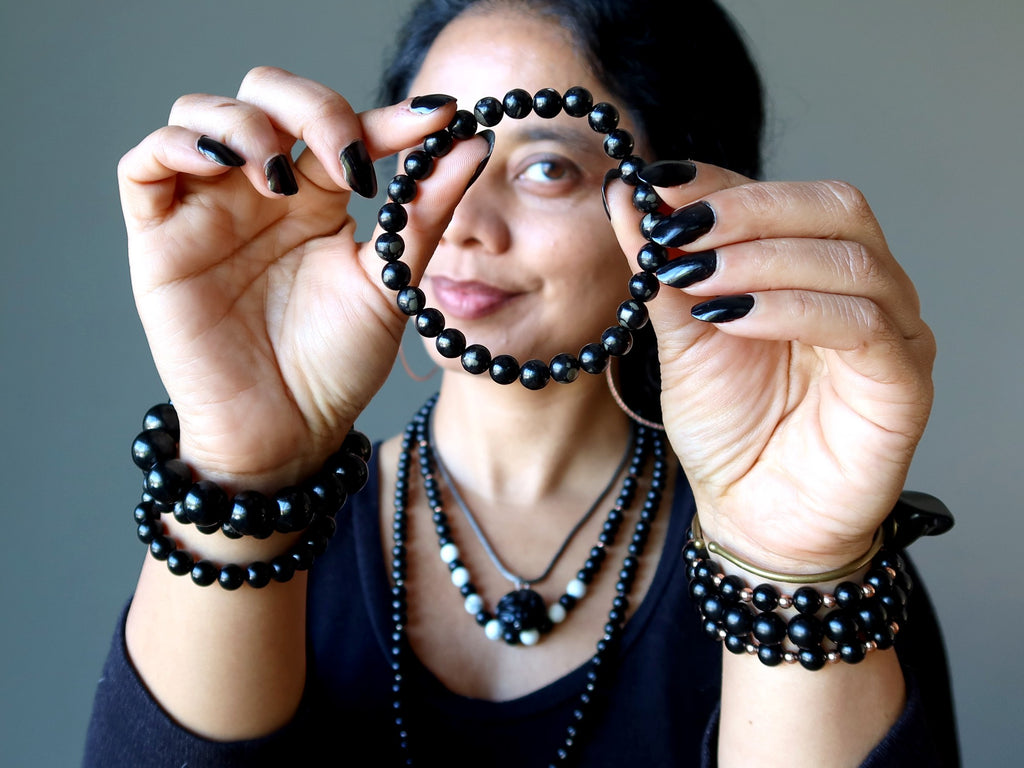 woman holding jet pyrite bracelet