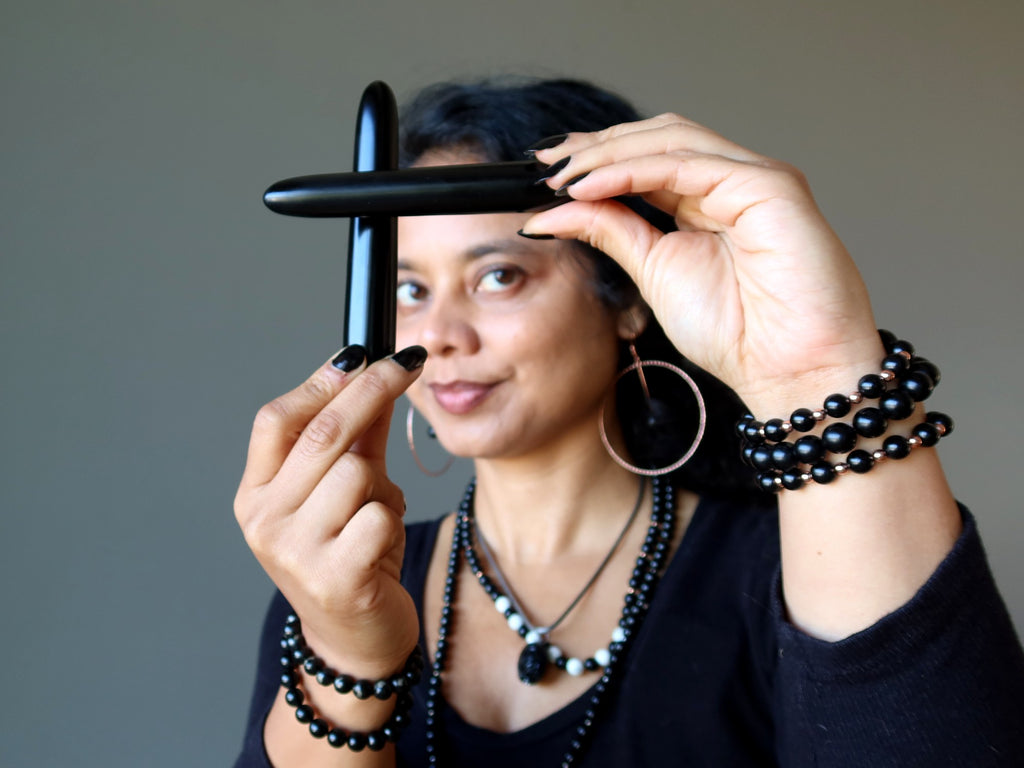 sheila of satin crystals holding jet wands