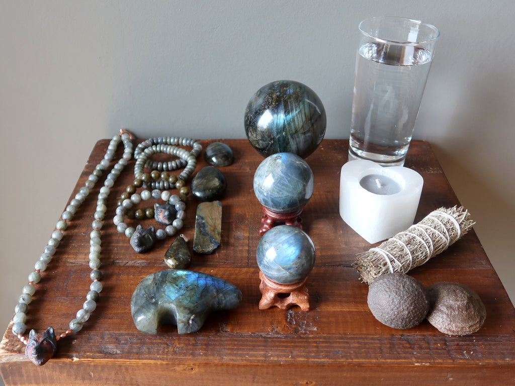 labradorite jewelry, stones, moqui marbles, sage, candle, water for meditation