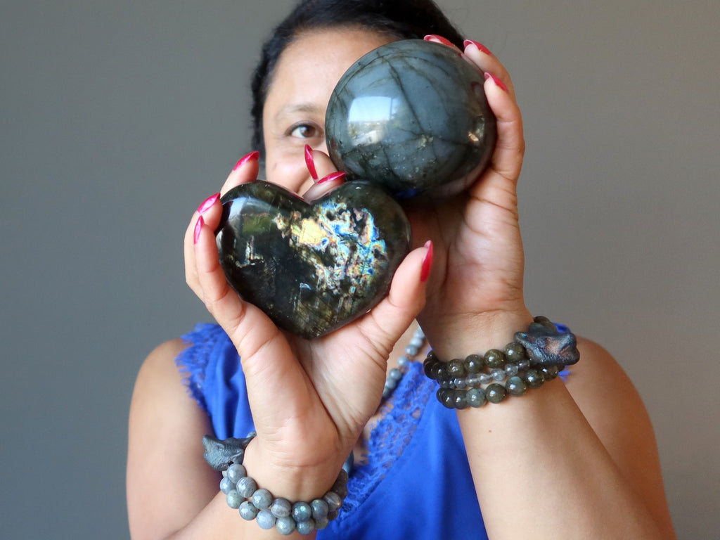 sheila of satin crystals holding up a labradorite sphere and heart
