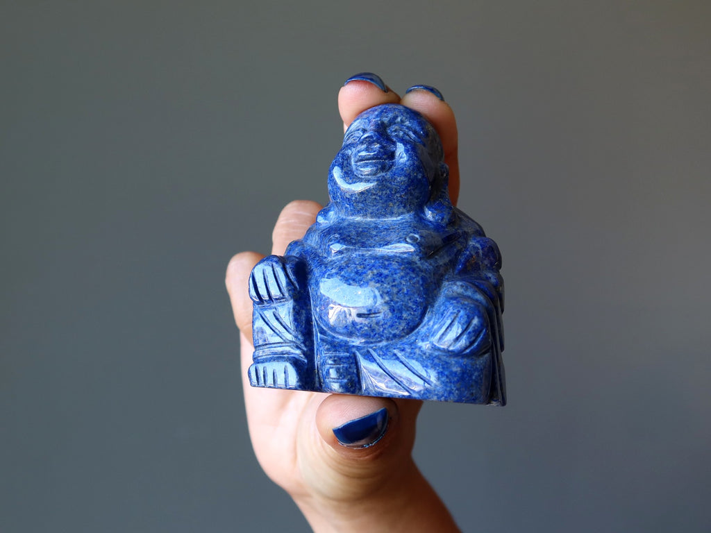 hand holding lapis buddha figurine