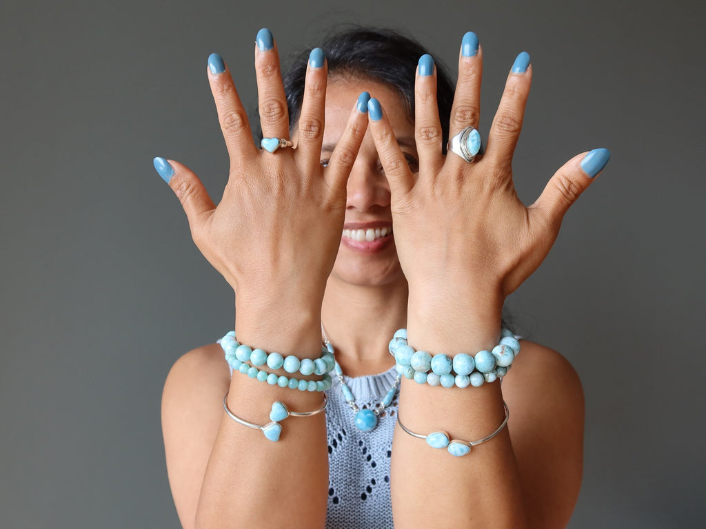 person wearing larimar jewelry