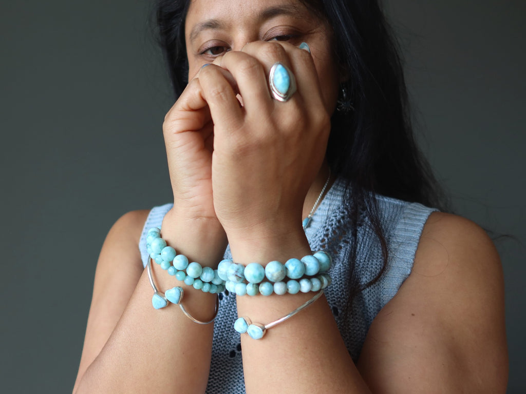 woman wearing larimar bracelets and rings
