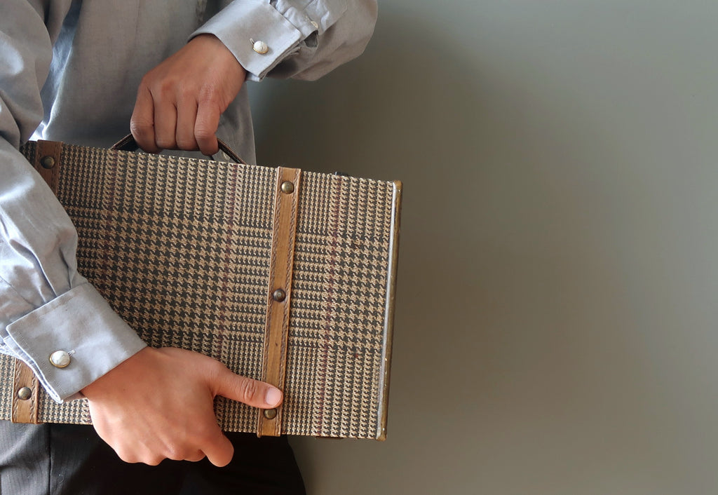 carrying a suitcase wearing howlite cufflinks