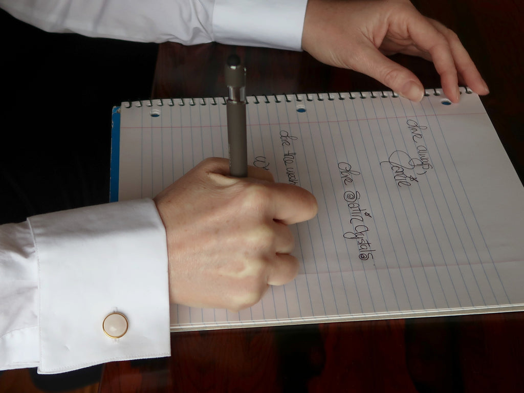 writing a note wearing rose quartz cufflinks