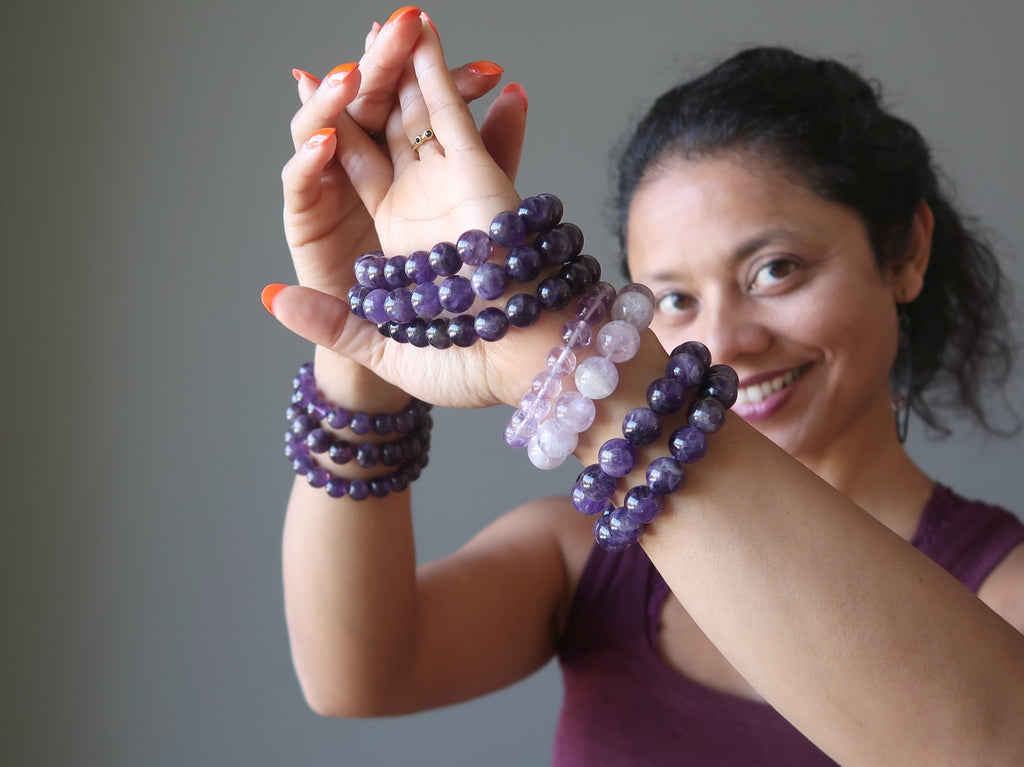 Model full of purple Amethyst stretch bracelets