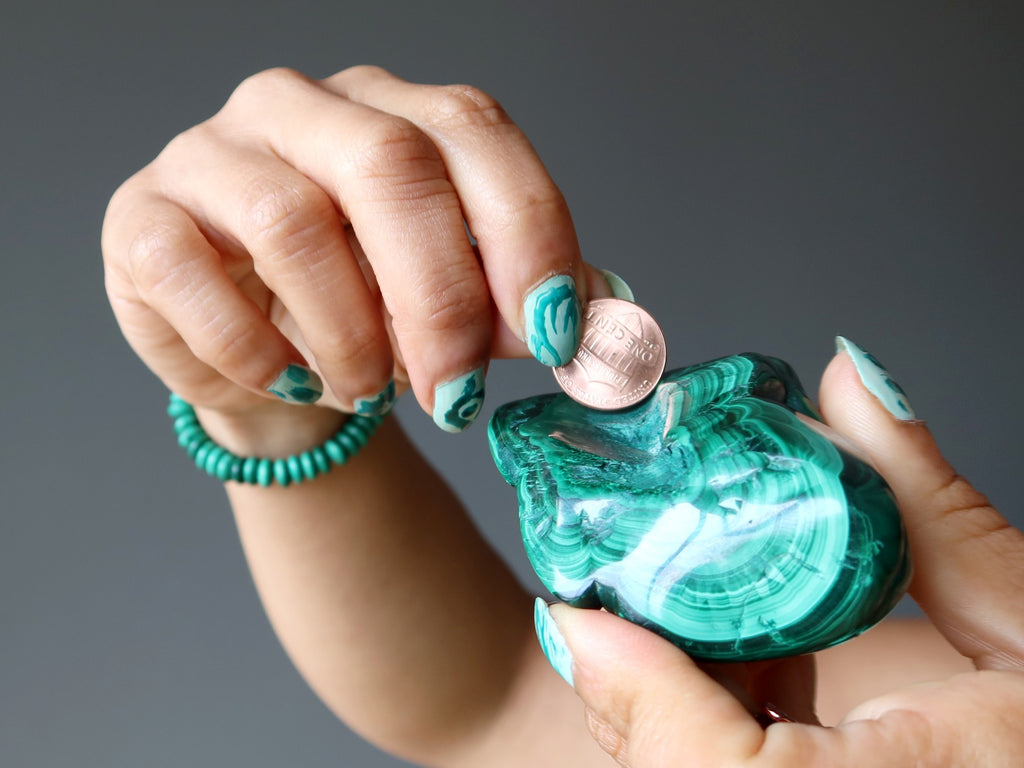 malachite chunk being scratched by a copper penny