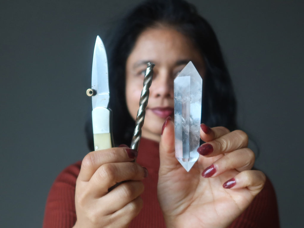 sheila of satin crystals holding quartz, knife and drill bit