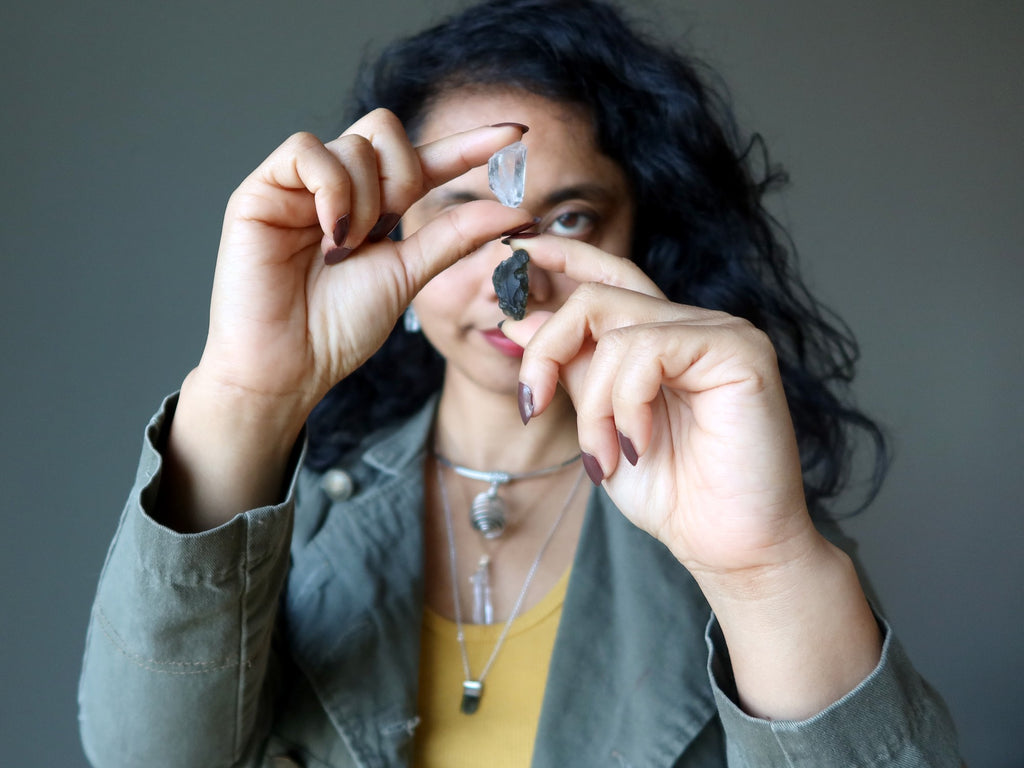 sheila of satin crystals holding and wearing moldavite and quartz together