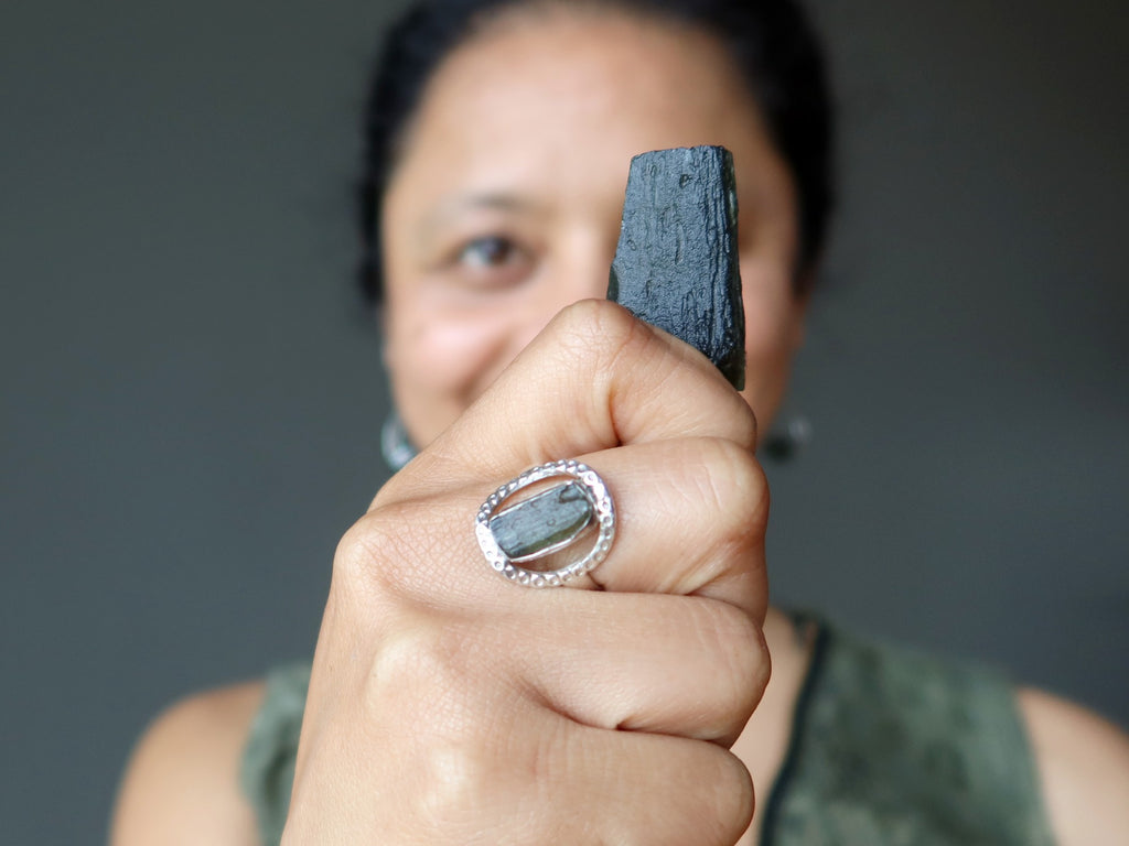 sheila of satin crystals holding moldavite rough wearing moldavite ring