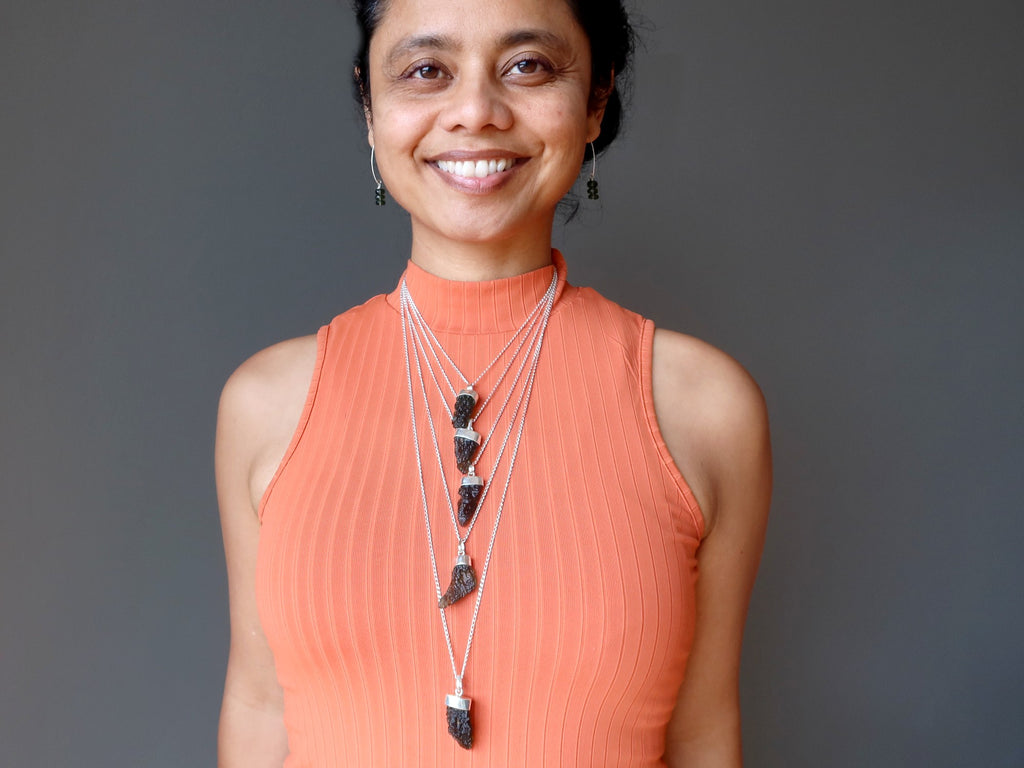 sheila of satin crystals wearing moldavite necklaces and earrings