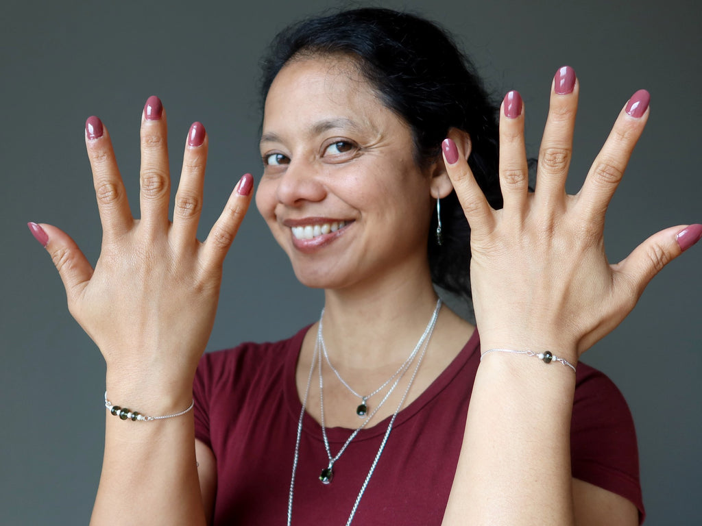 sheila of satin crystals showing off new moldavite jewelry