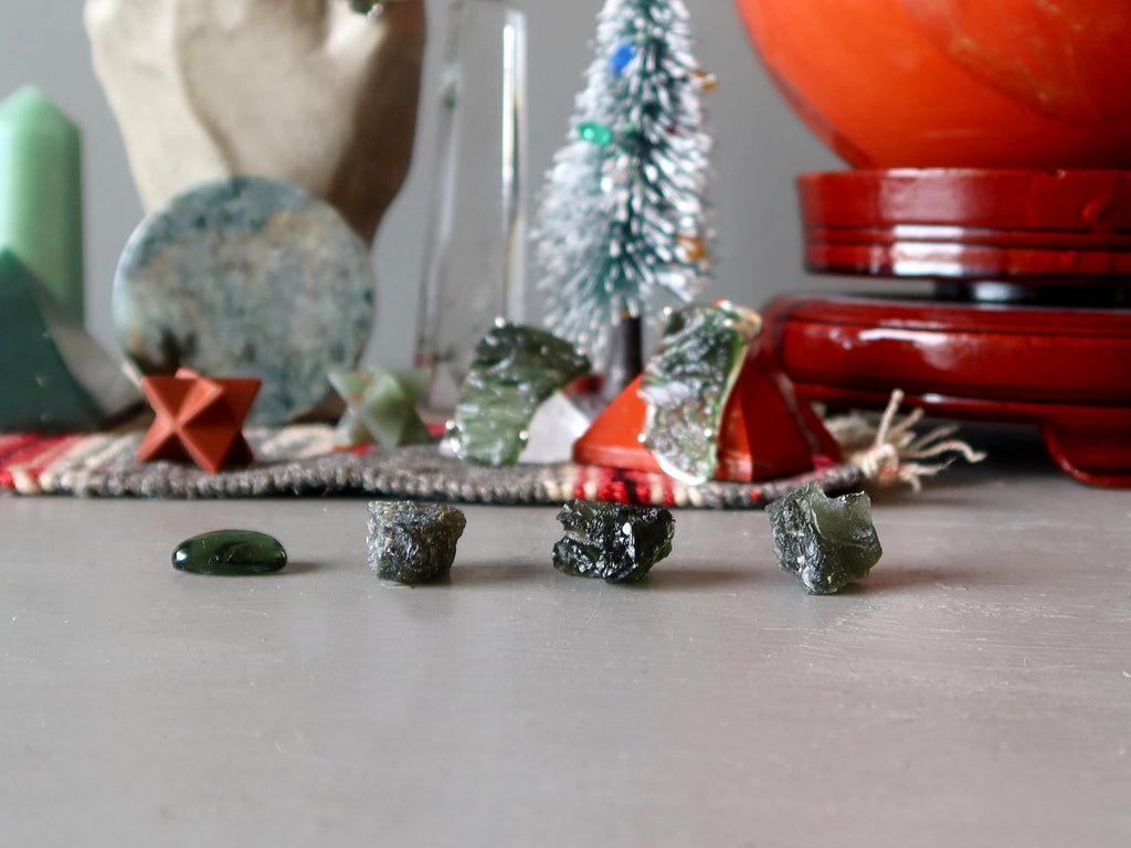 raw moldavite stones in holiday setting