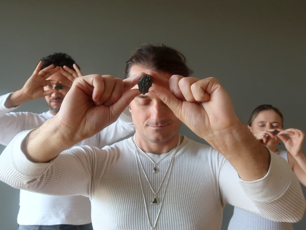 three people with moldavite at their foreheads