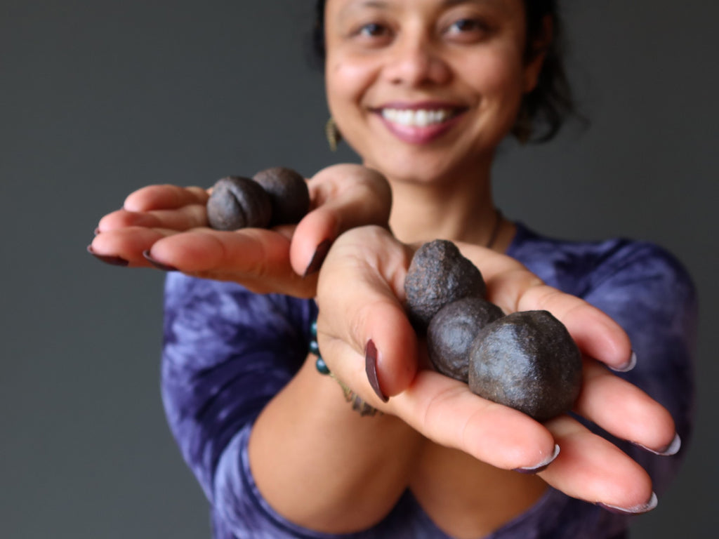 sheila of satin crystals holding 5 moqui marble stones in her hands