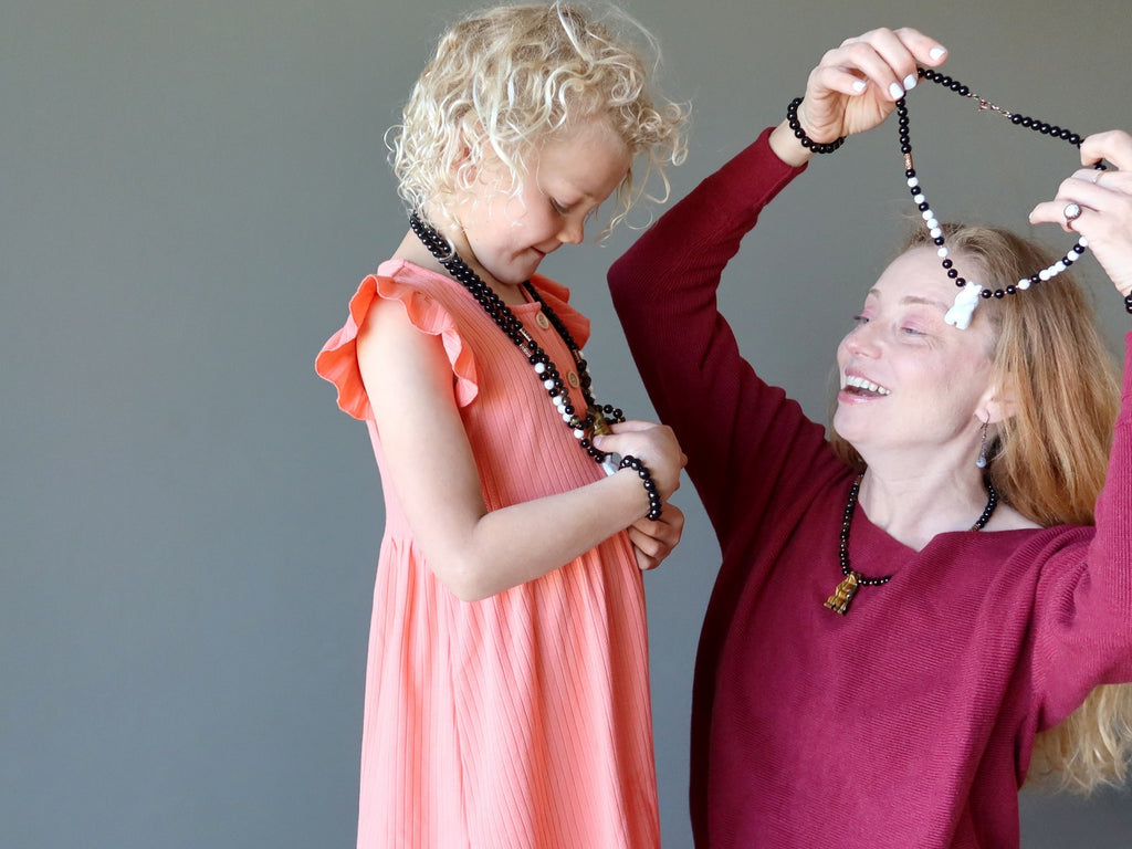 mother and daughter wearing crystal bear necklaces