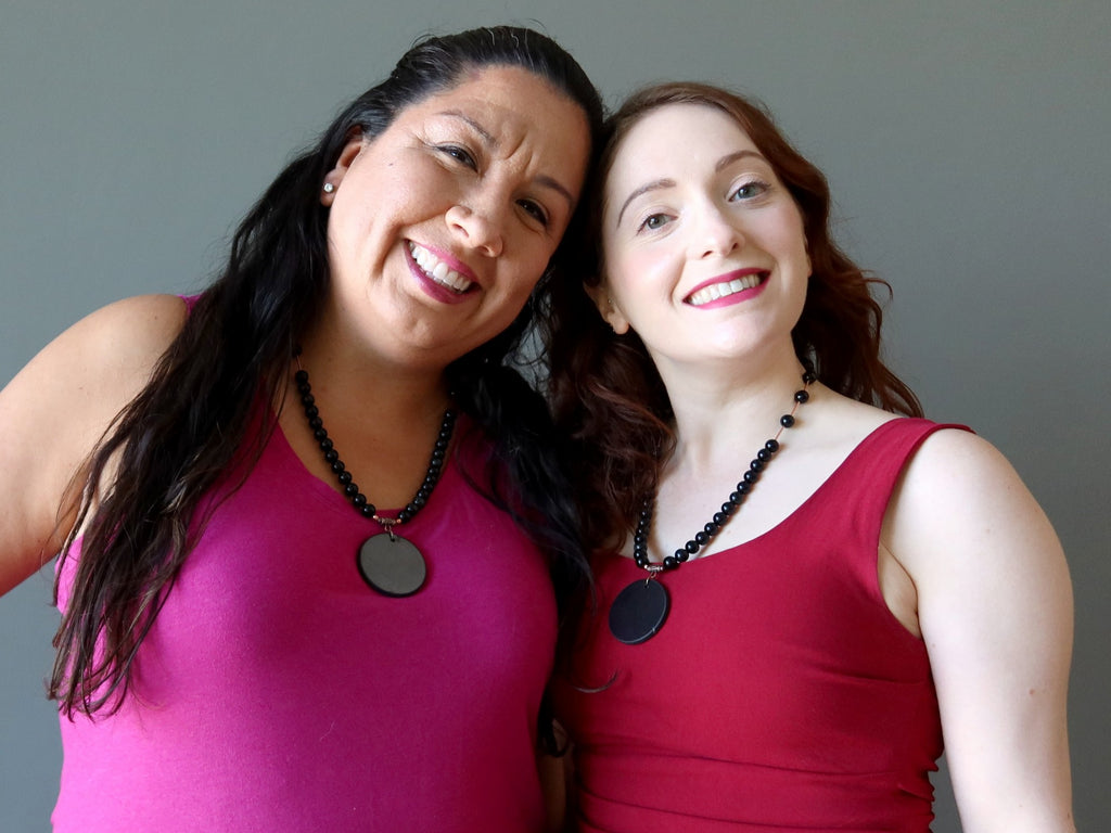 two ladies wearing obsidian shungite necklaces
