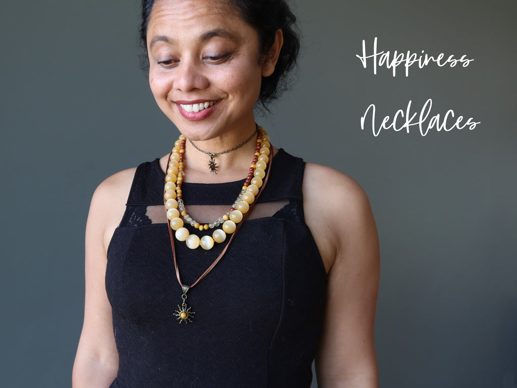 sheila of satin crystals wearing jasper sun, selenite, citrine necklaces for happiness