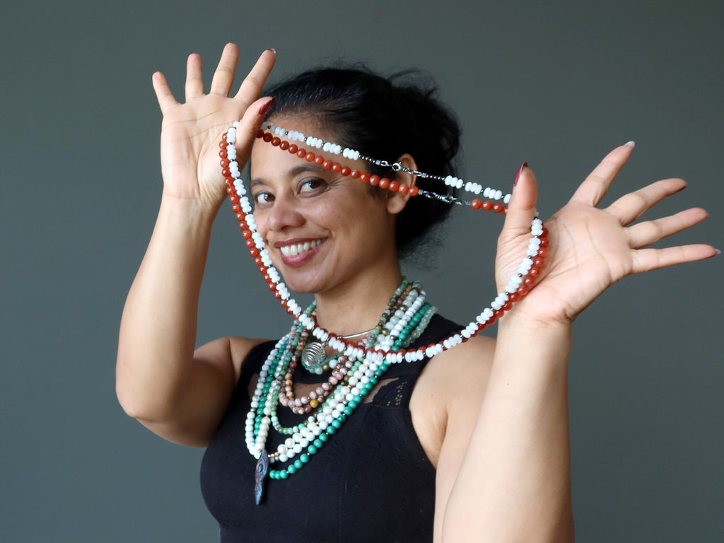 sheila of satin crystals holding and wearing crystal necklaces