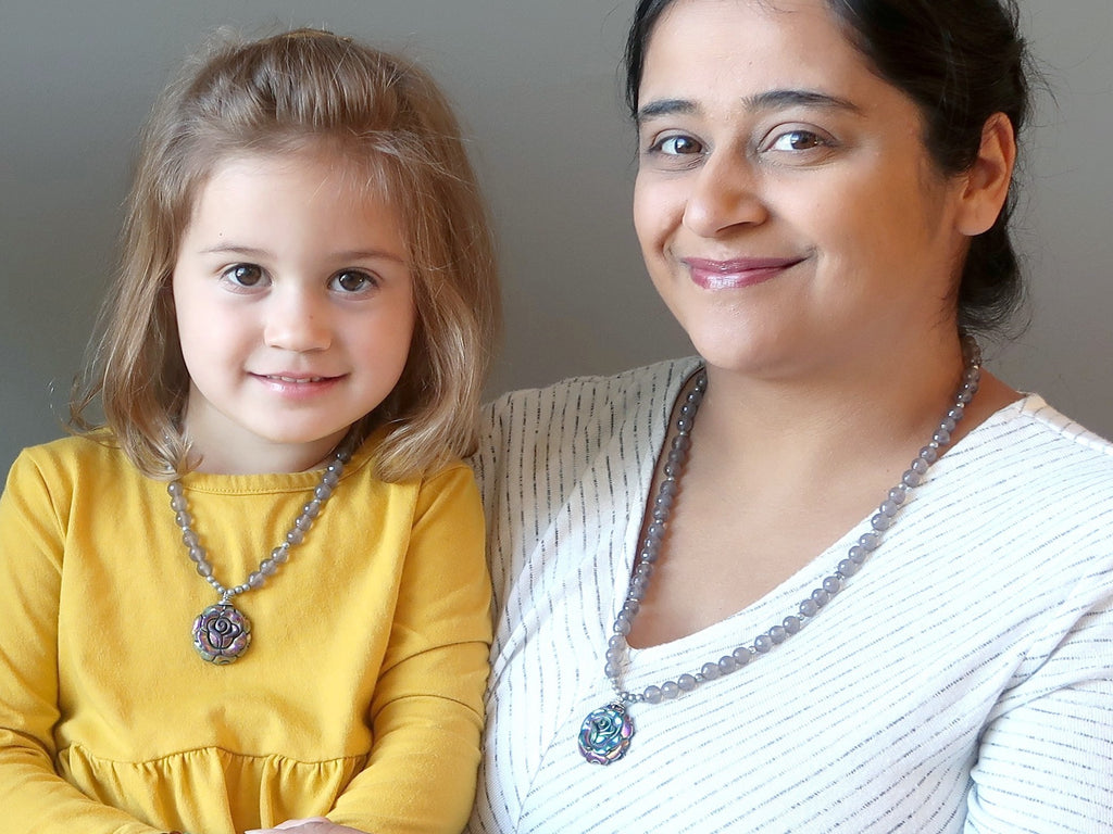 mother and daughter wearing matching crystal healing necklaces