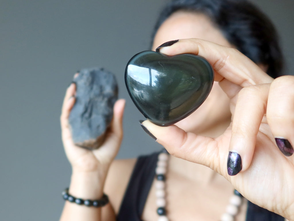 Sheila of Satin Crystals holding a polished heart and a rough Obsidian stone