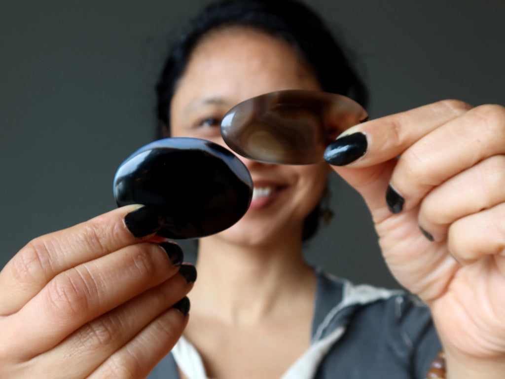 sheila of satin crystals holding onyx and sardonyx oval slabs