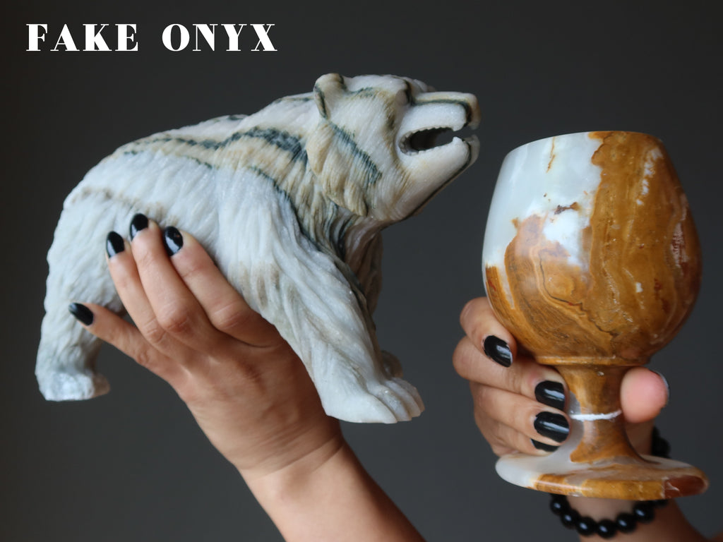 hands holding a cave onyx bear and cup as fake onyx examples