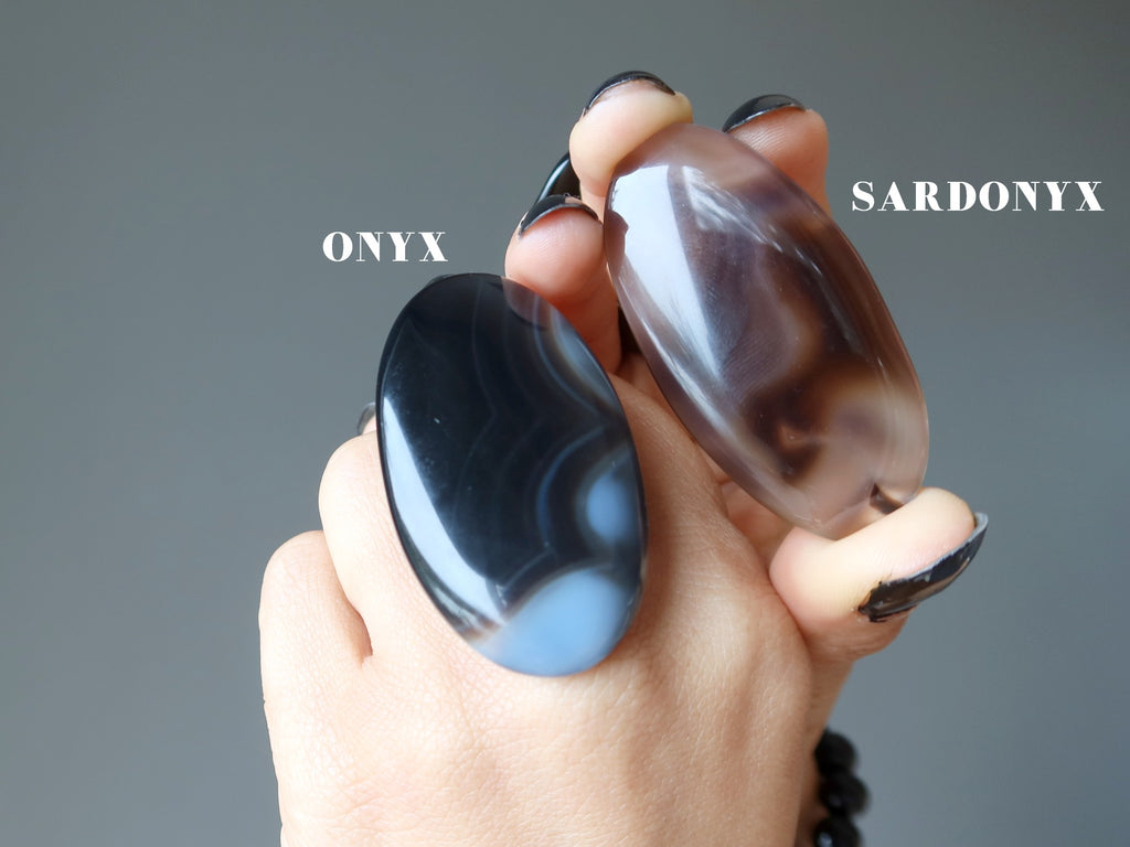 hands holding a onyx and sardonyx oval