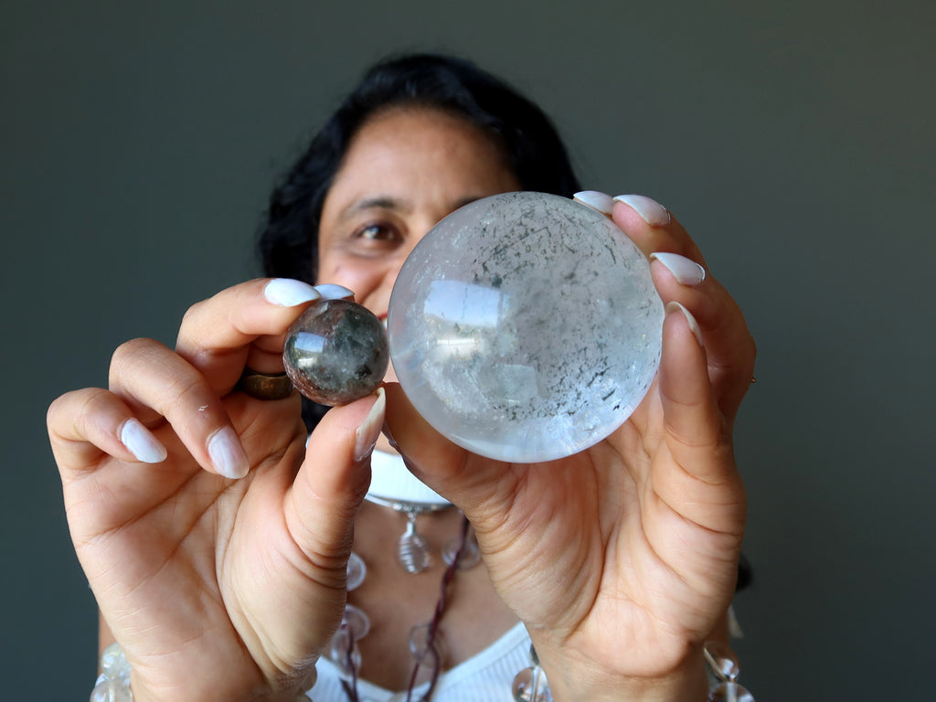 sheila of satin crystals holding two included quartz crystal balls