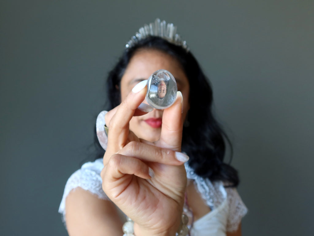 sheila of satin crystals wearing quartz jewelry and holding quartz egg