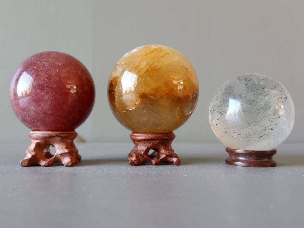 hematite quartz, golden healer and clear quartz spheres on stands