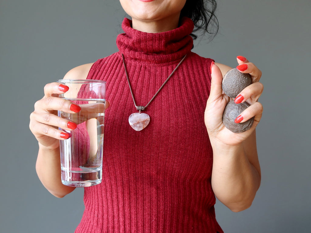 woman holding water and moqui marbles