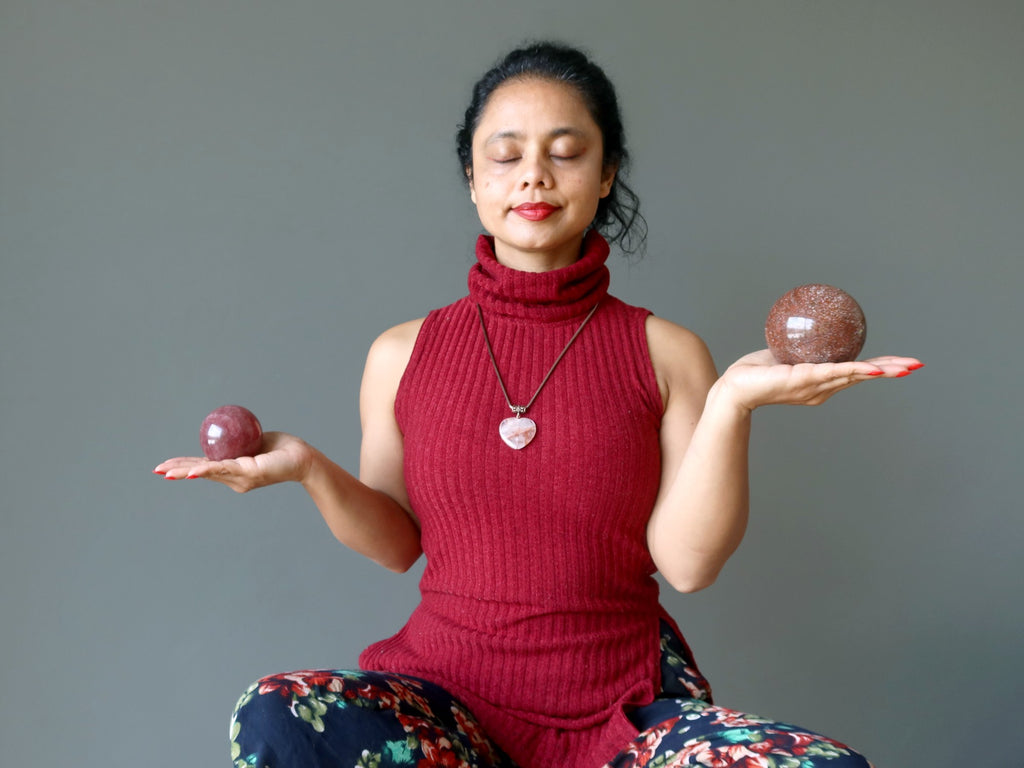 sheila of satin crystals meditating with red quartz spheres