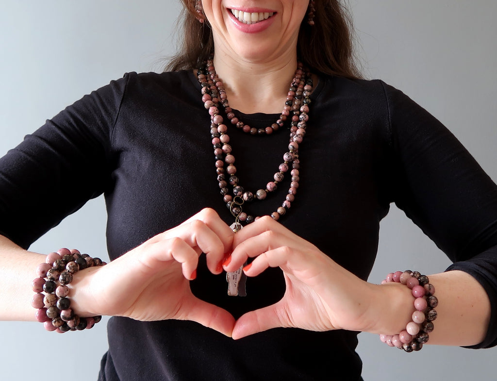 woman wearing rhodonite jewelry