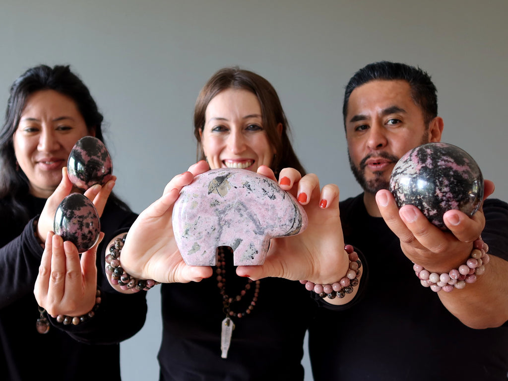 people holding and wearing rhodonite