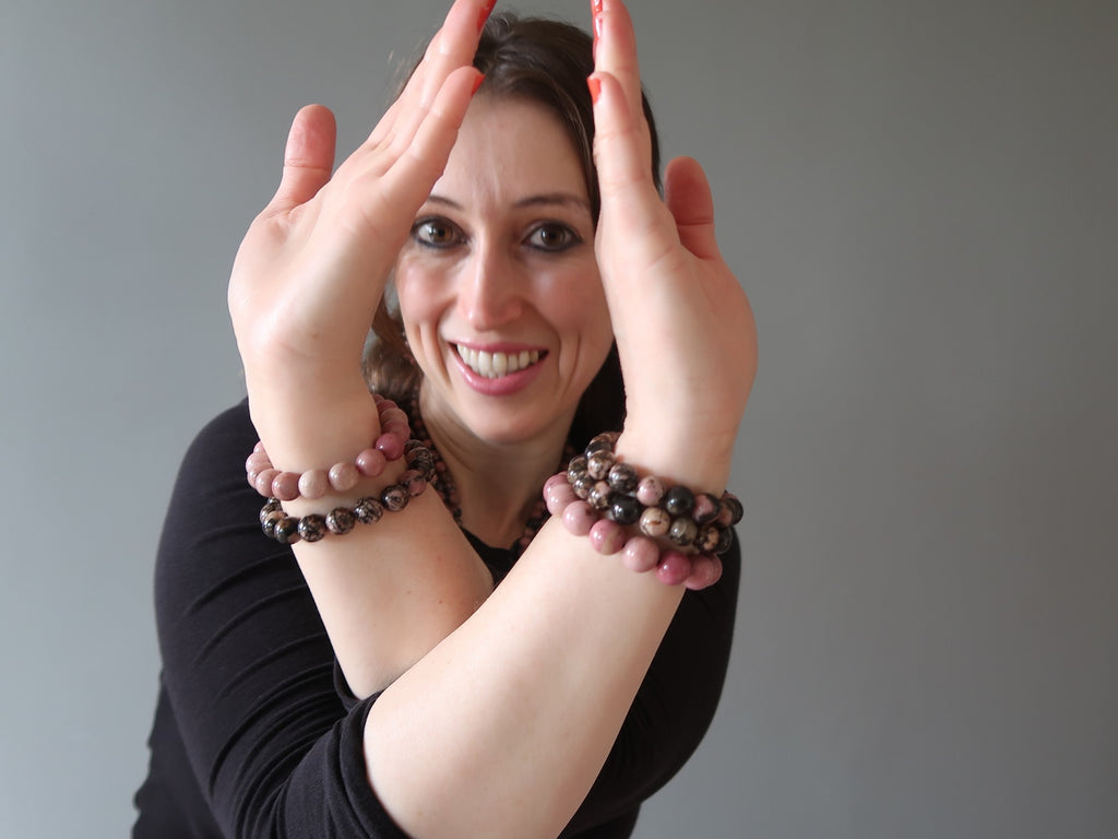 woman wearing rhodonite jewelry