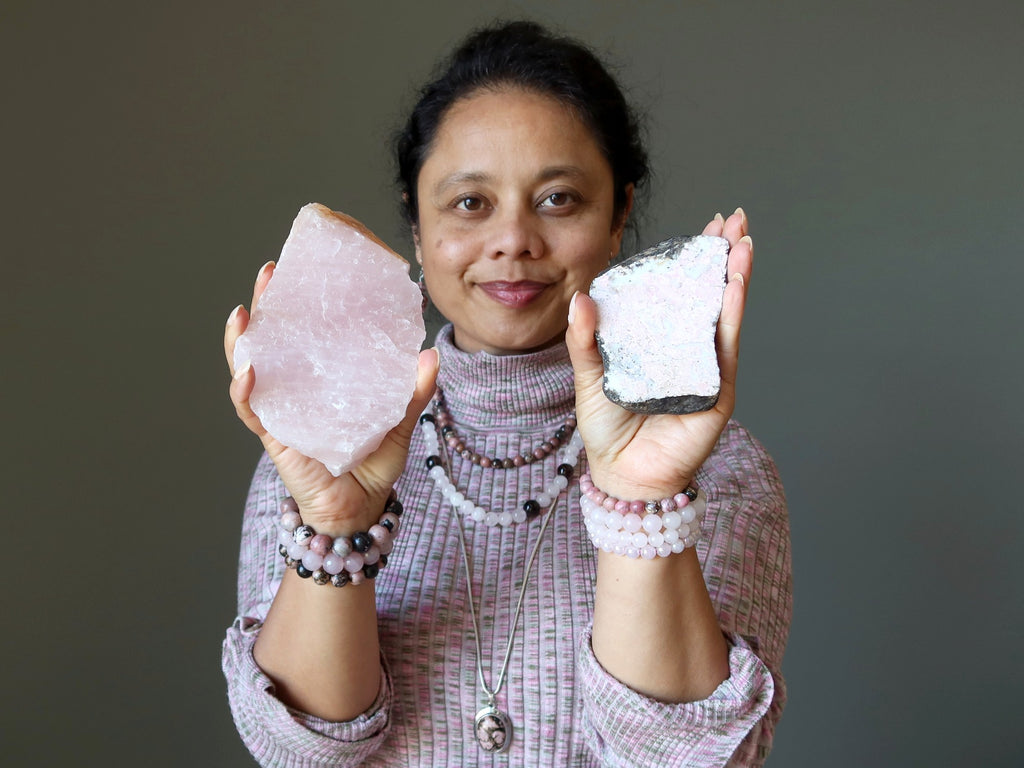 woman holding rose quartz and rhodonite