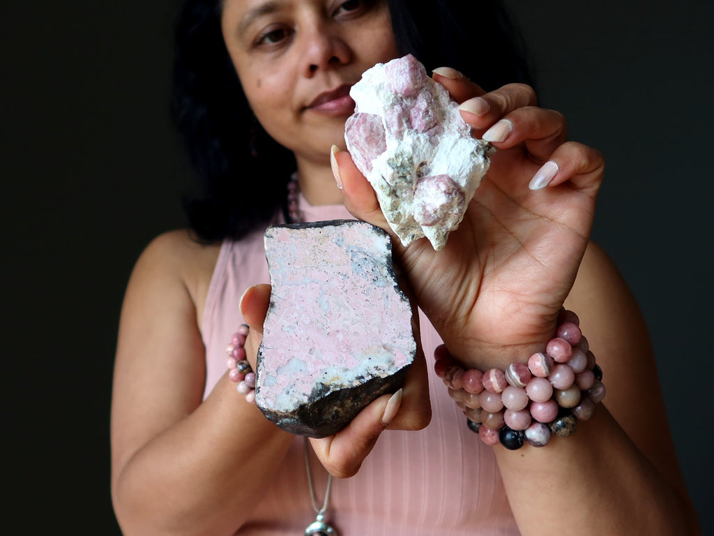 woman holding rosolite garnet and rhodonite