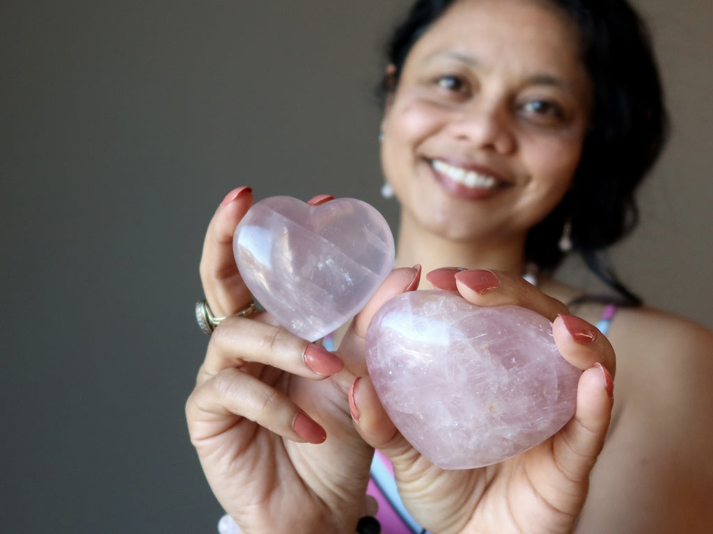 sheila of satin crystals holding two pink rose quartz hearts