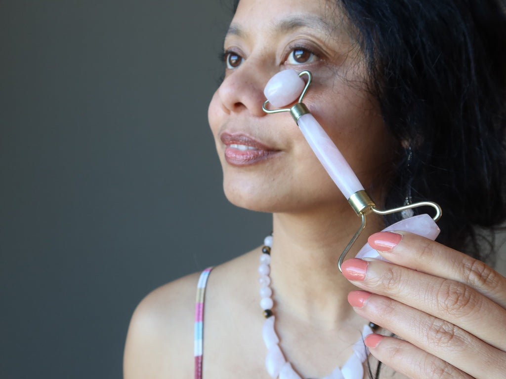 sheila of satin crystals using a rose quartz facial roller on her face