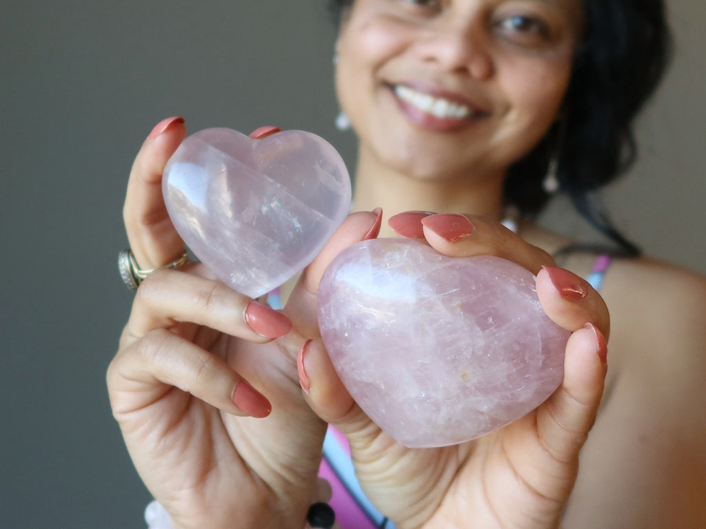 sheila of satin crystals holding two pink rose quartz hearts